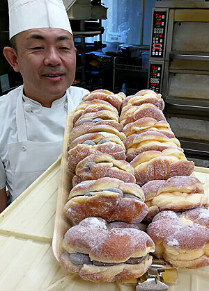 Portrait von Tokyos bekanntestem Bäcker, Herrn Ihara, mit einer Lade voll Süßgebäck