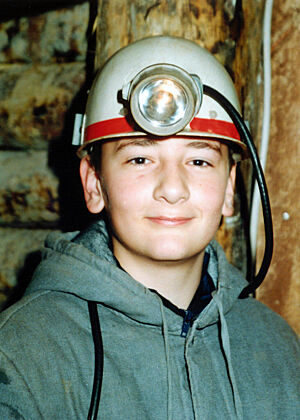 Bild eines 12-jährigen Jungen mit Grubenhelm und Stirnlampe